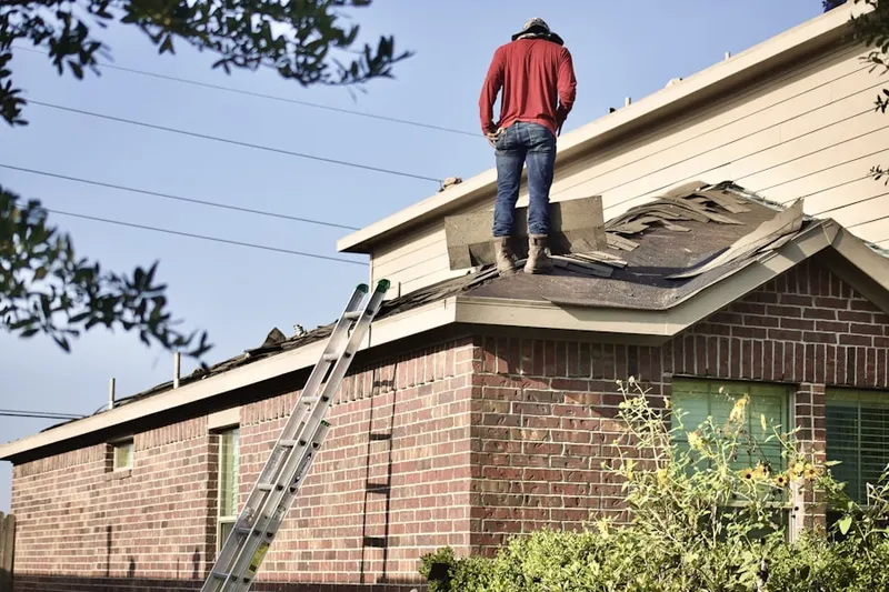 Professional roofer working on a residential roof in Fairfield Crest